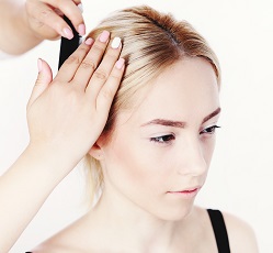 Woman is getting her hair cut by a hairdresser